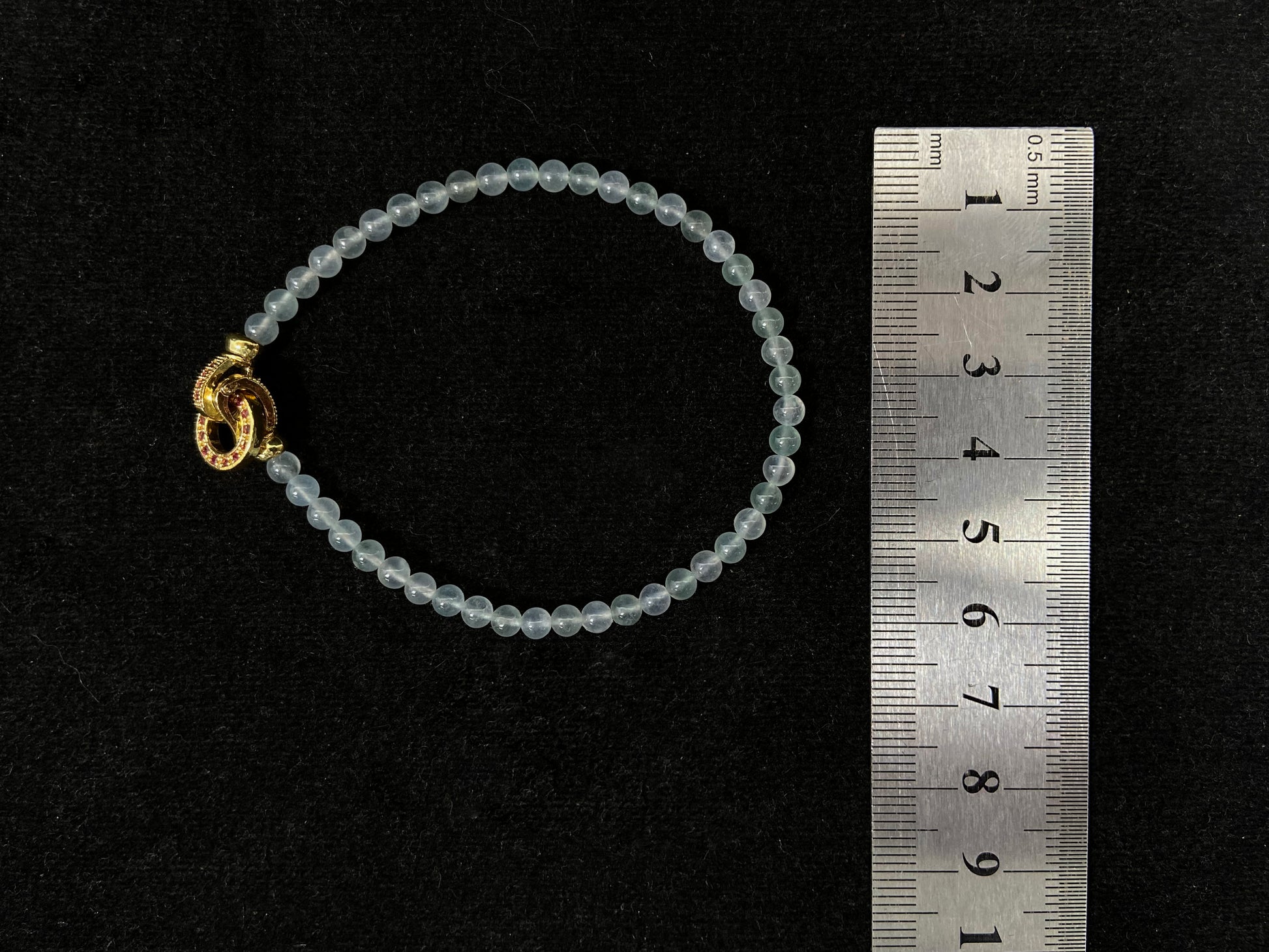 An icy jade bead bracelet with a golden clasp.
