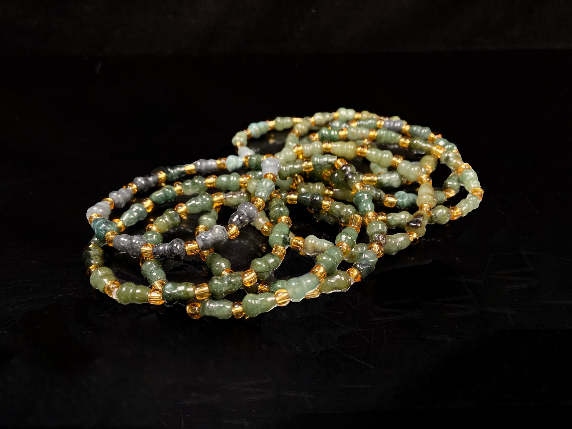 A green hue gourd beads jadeite beads bracelet group.