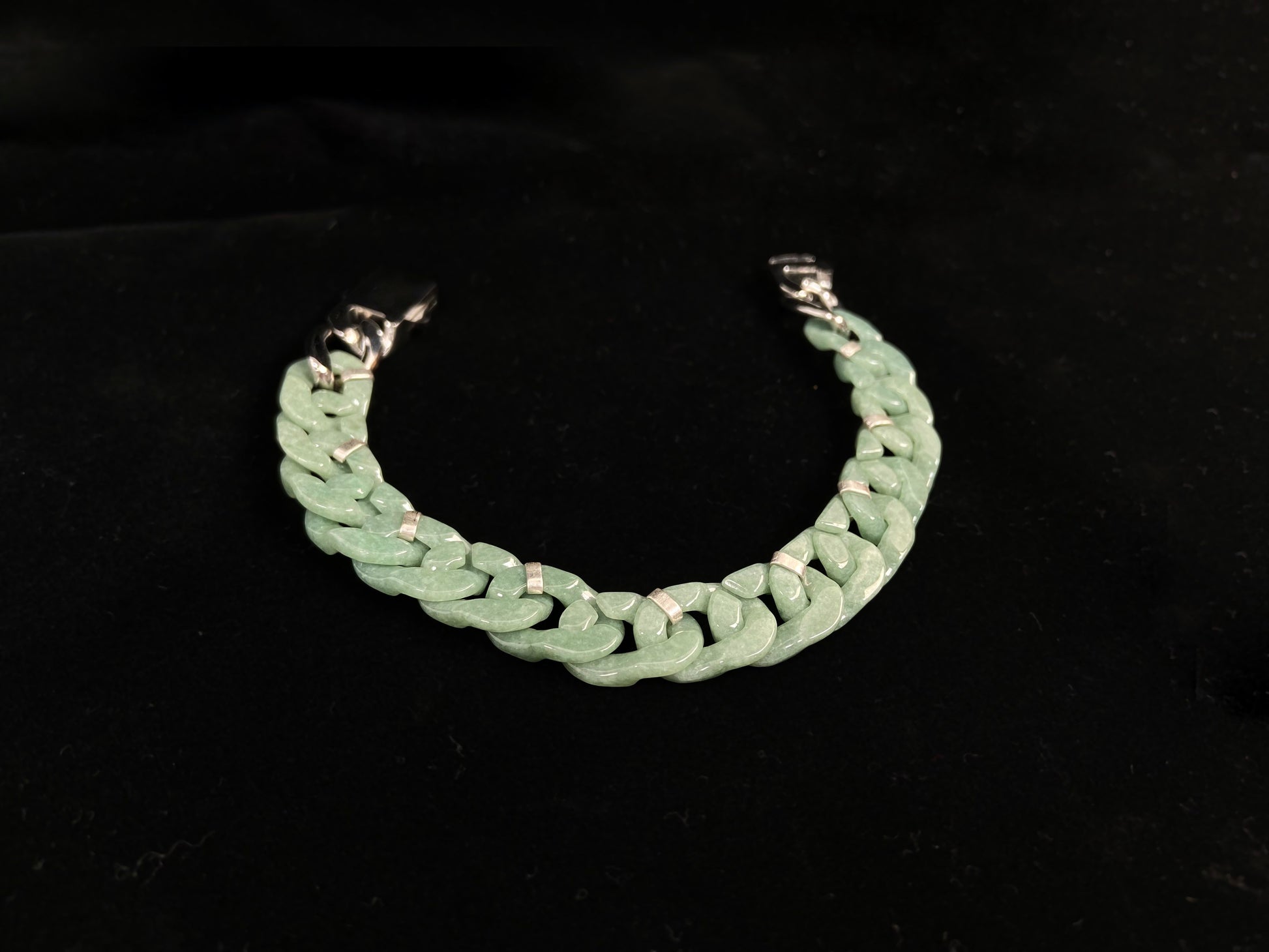 A pea green jadeite Cuban chain bracelet.