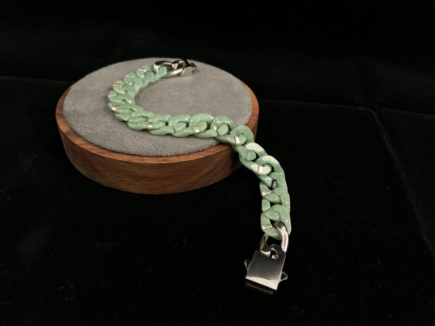A pea green jadeite Cuban chain bracelet.