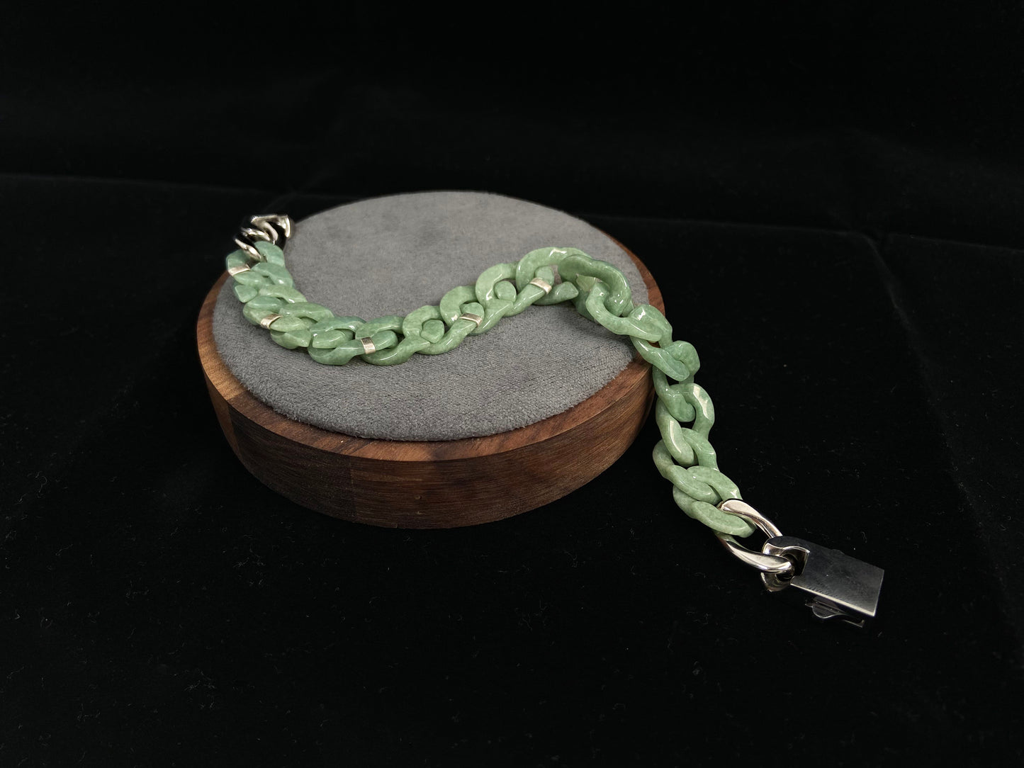 A pea green jadeite Cuban chain bracelet.