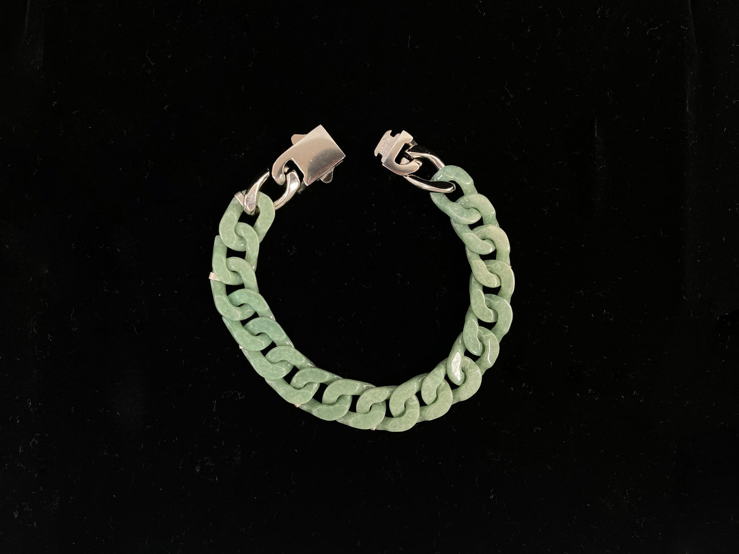 A pea green jadeite Cuban chain bracelet.