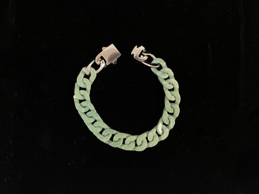 A pea green jadeite Cuban chain bracelet.