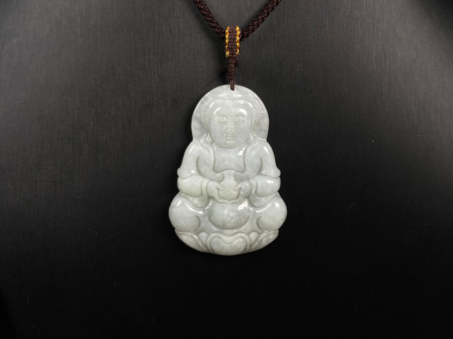 A purple green Guanyin blessing jadeite pendant.