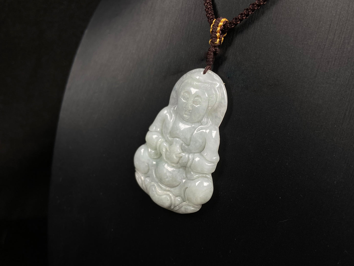 A purple green Guanyin blessing jadeite pendant.