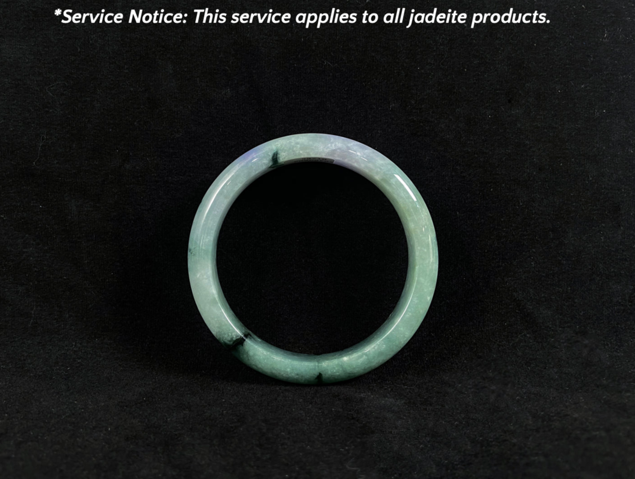 Green jadeite ring on a black background with text about service applicability.