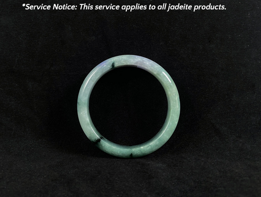 Green jadeite ring on a black background with text about service applicability.