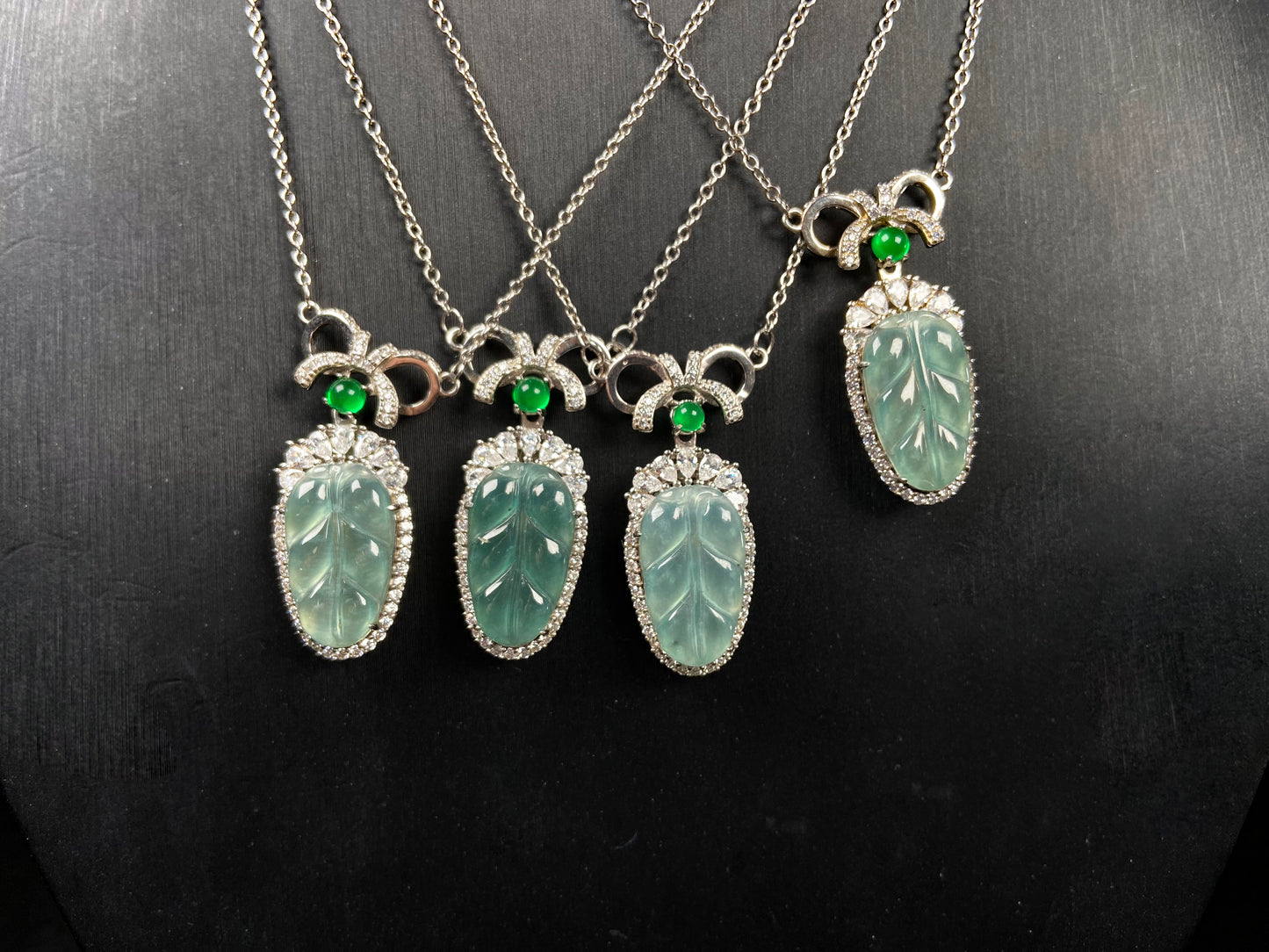 A lucky leaf with green bead jadeite pendant group.