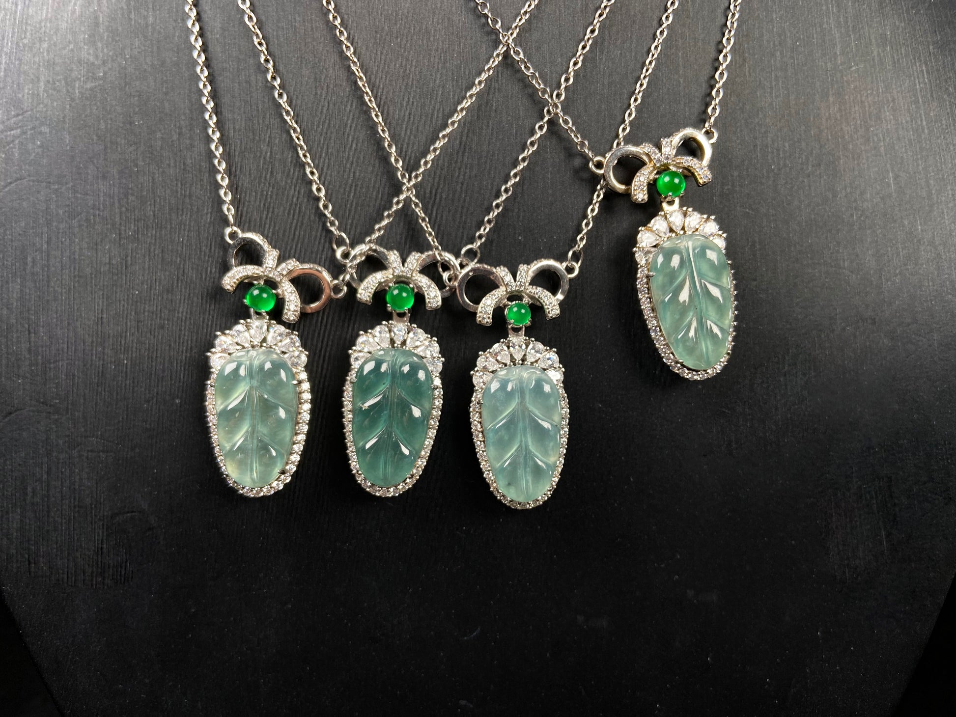 A lucky leaf with green bead jadeite pendant group.
