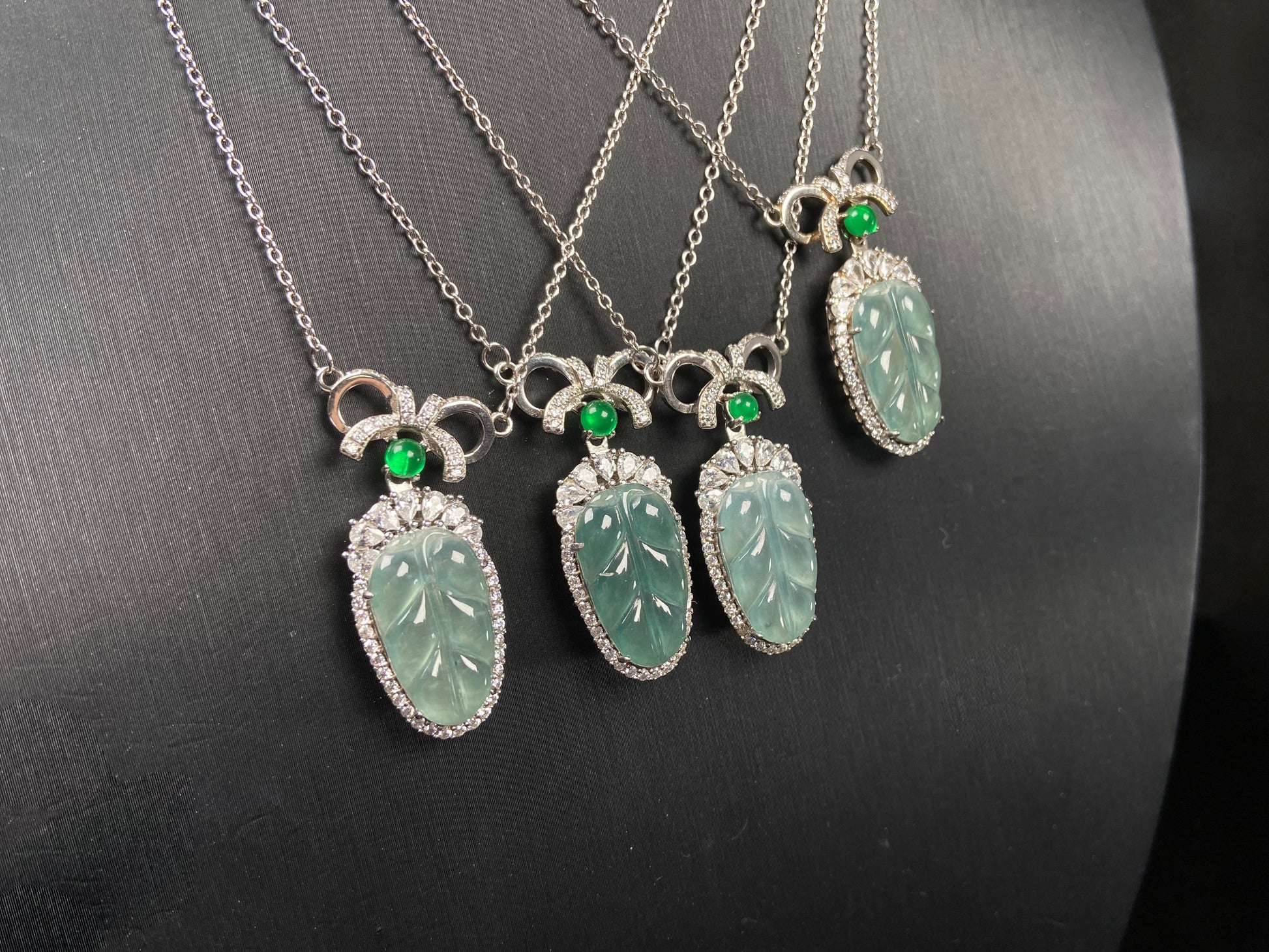 A lucky leaf with green bead jadeite pendant group.
