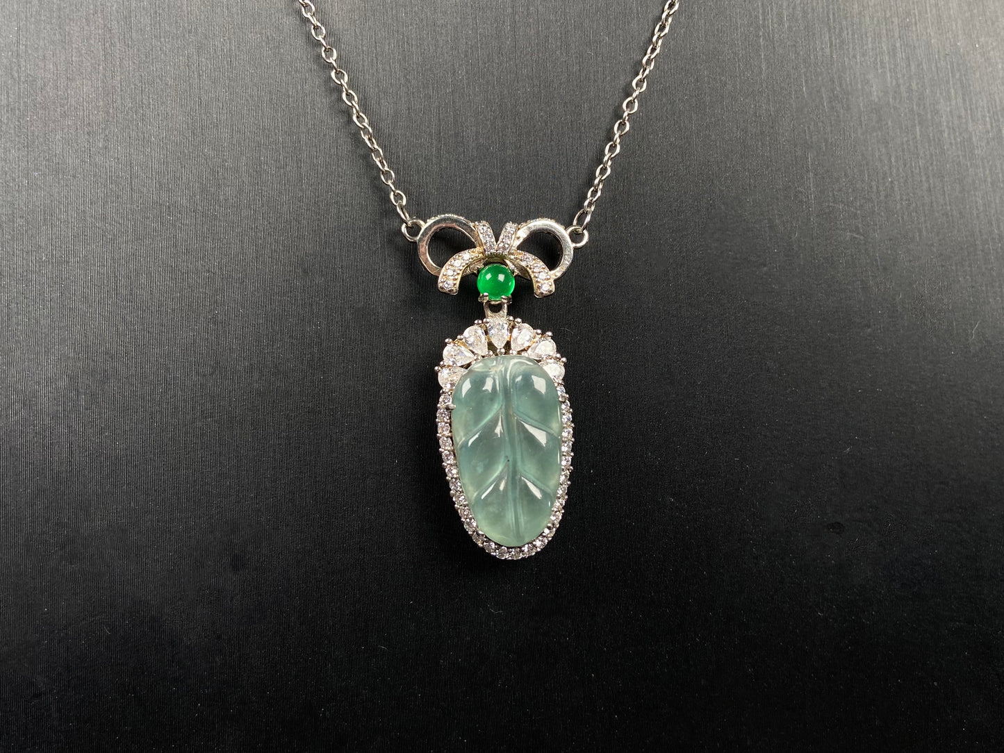 A lucky leaf with green bead jadeite pendant.