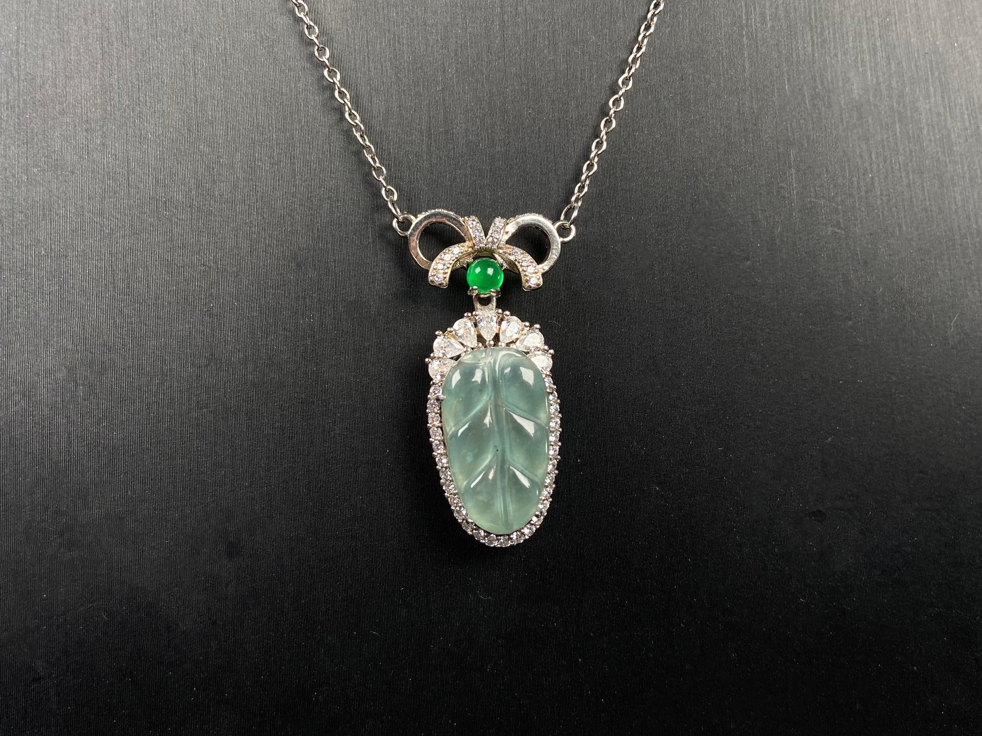 A lucky leaf with green bead jadeite pendant.
