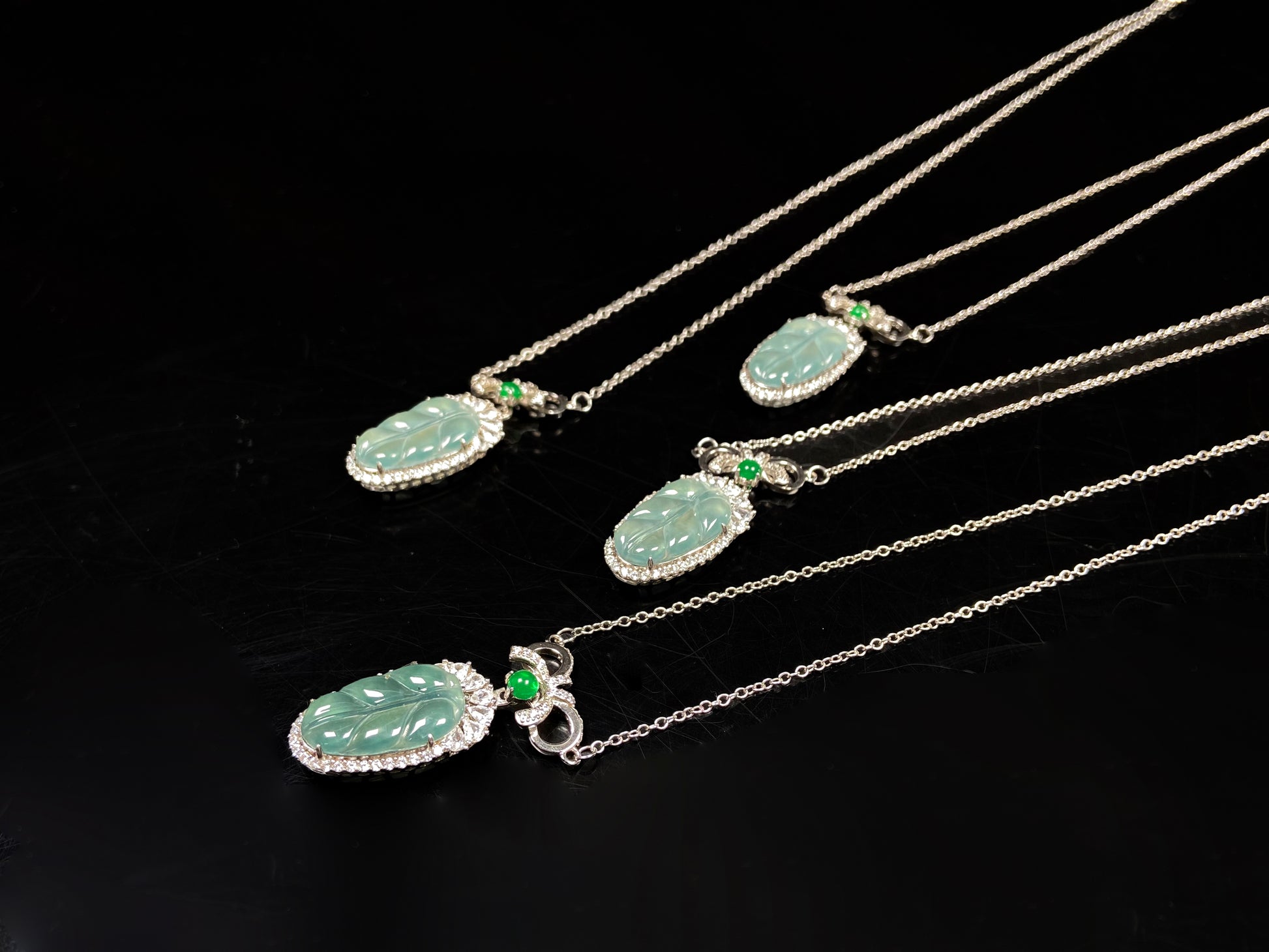 A lucky leaf with green bead jadeite pendant group.
