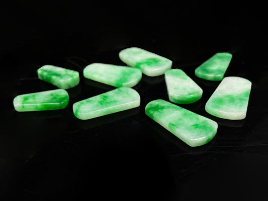 A floating green Wu Shi Pai loose jadeite group.