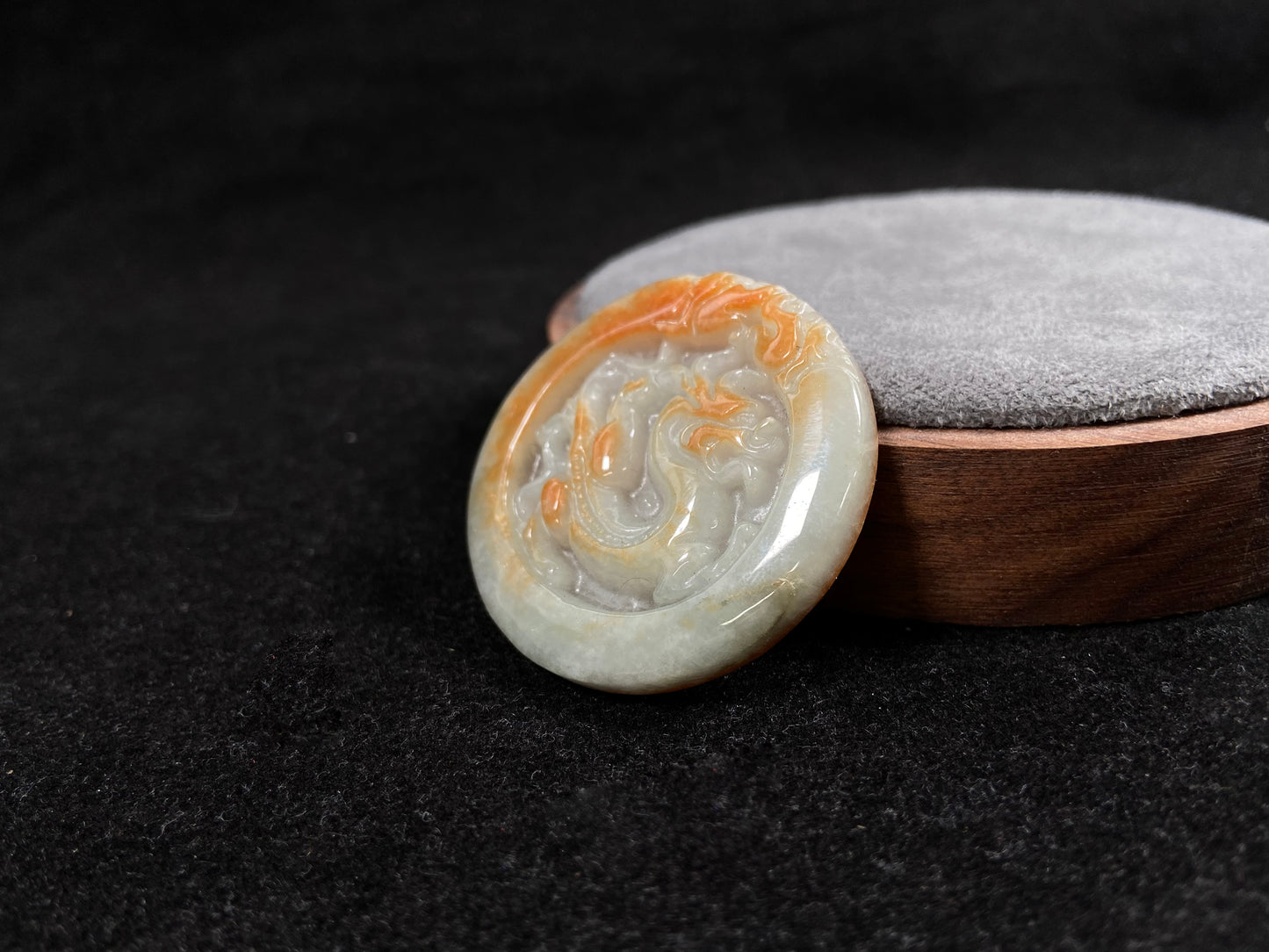 A milky white jadeite dragon plaque with gold speckles.