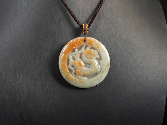 A milky white jadeite dragon plaque with gold speckles.