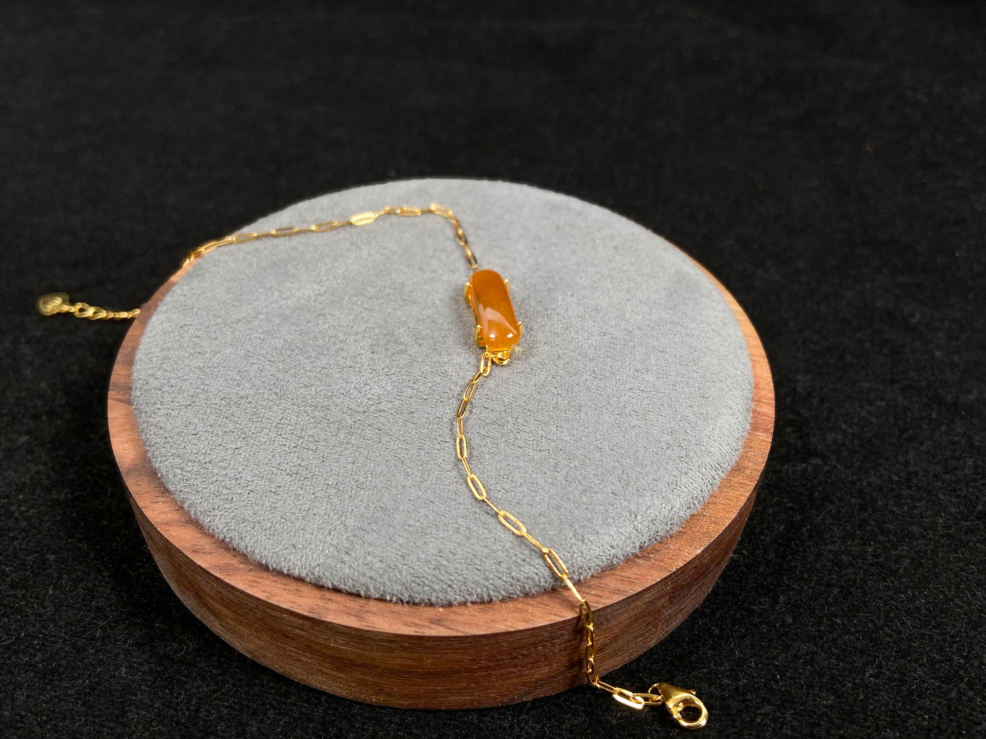 A saddle-shaped jadeite bracelet in a golden brown hue.