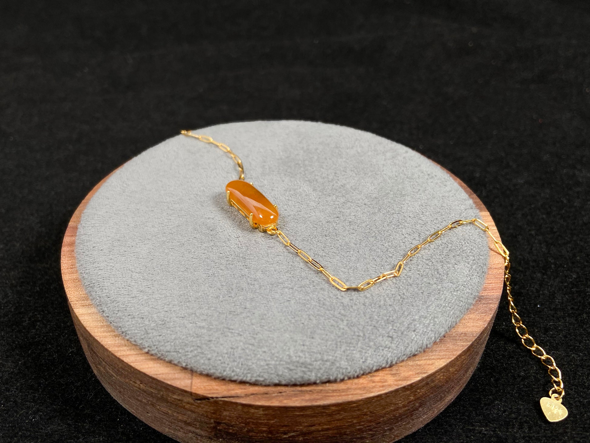 A saddle-shaped jadeite bracelet in a golden brown hue.