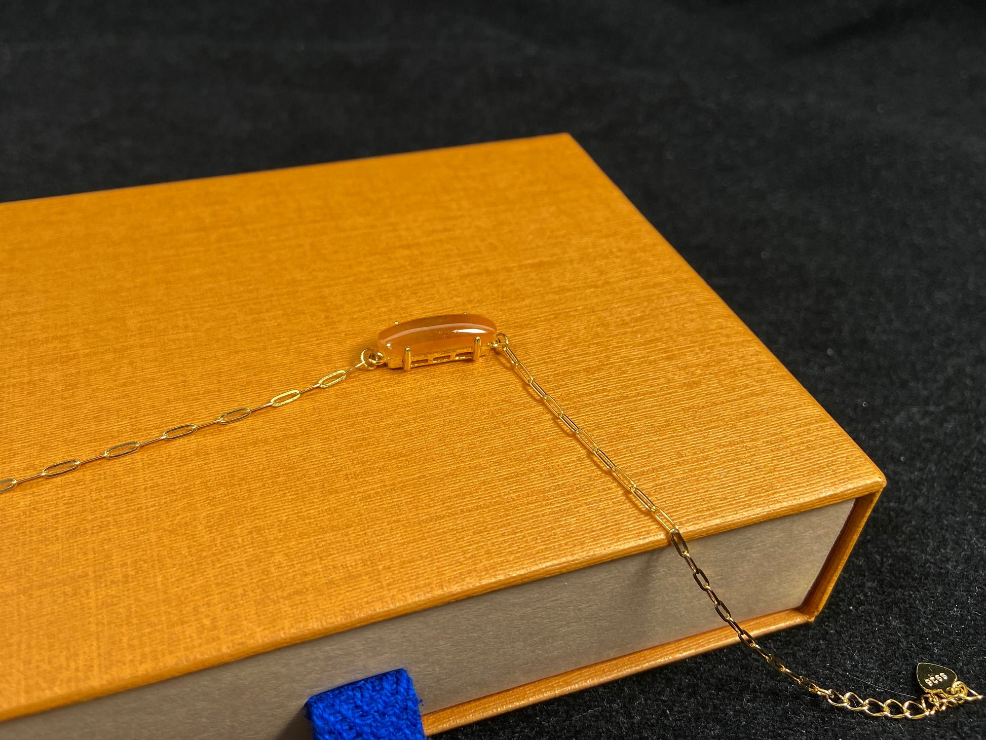 A saddle-shaped jadeite bracelet in a golden brown hue.