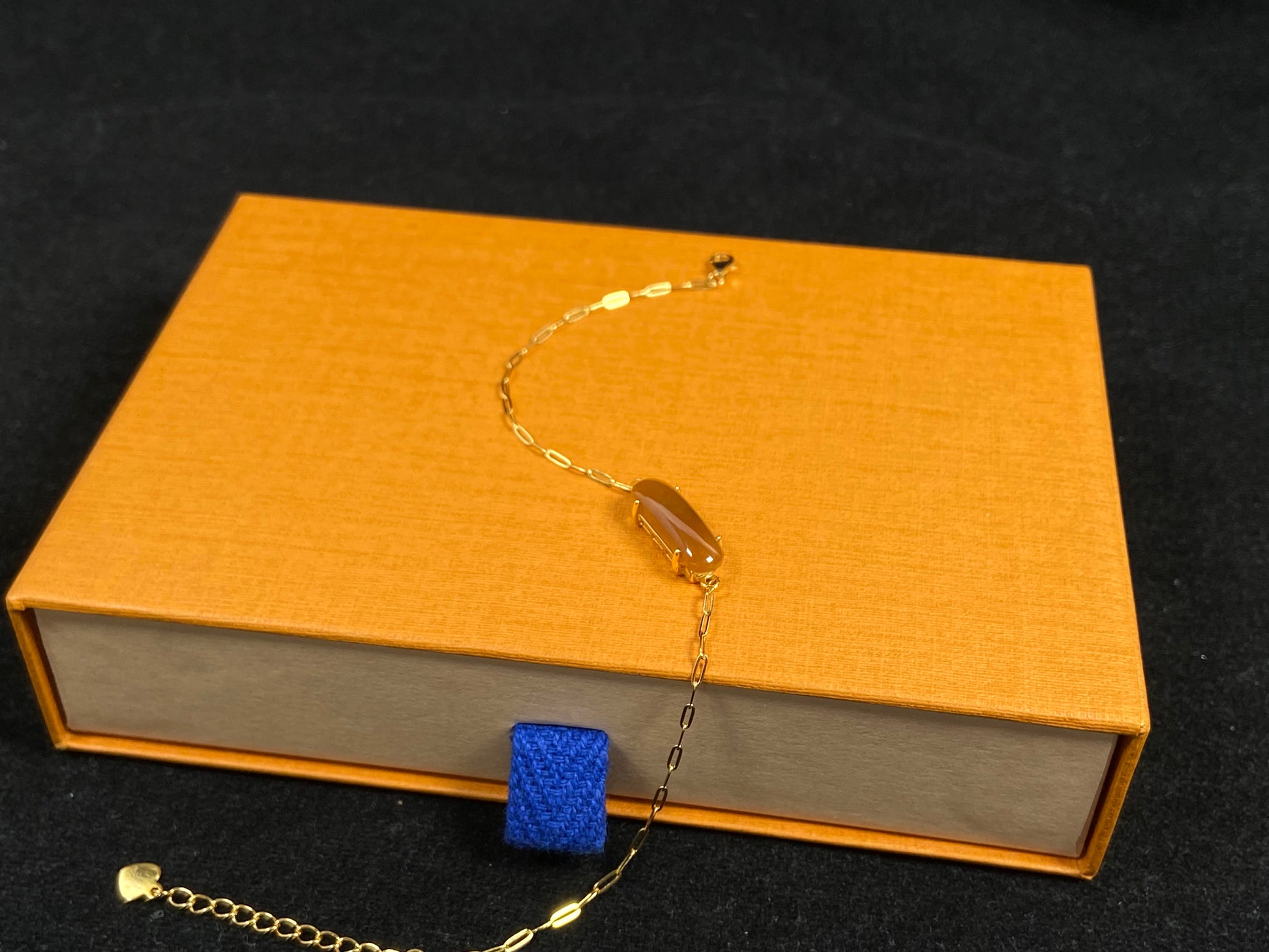 A saddle-shaped jadeite bracelet in a golden brown hue.