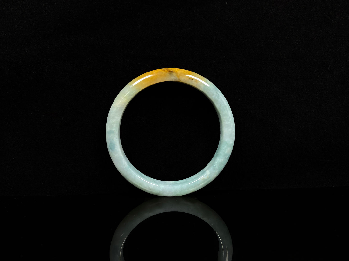 A white and gold jadeite bangle.