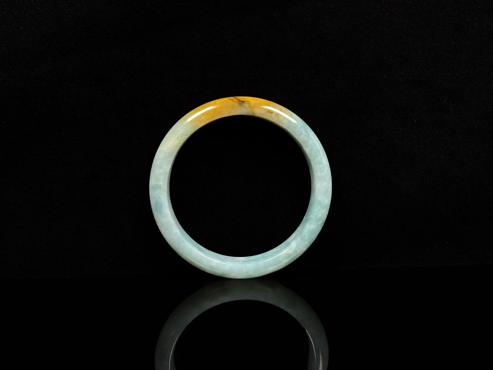 A white and gold jadeite bangle.