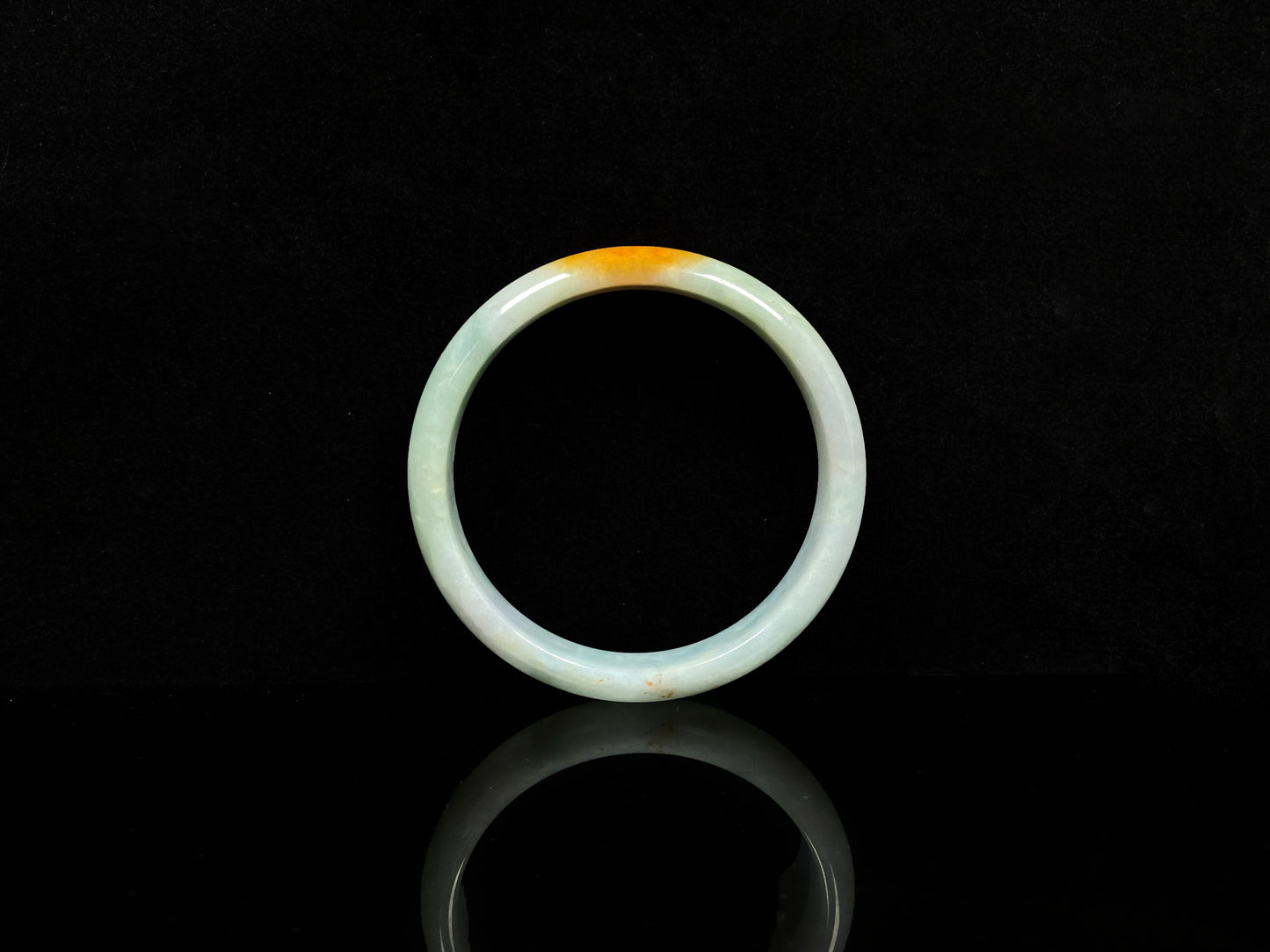 A white and gold jadeite bangle.