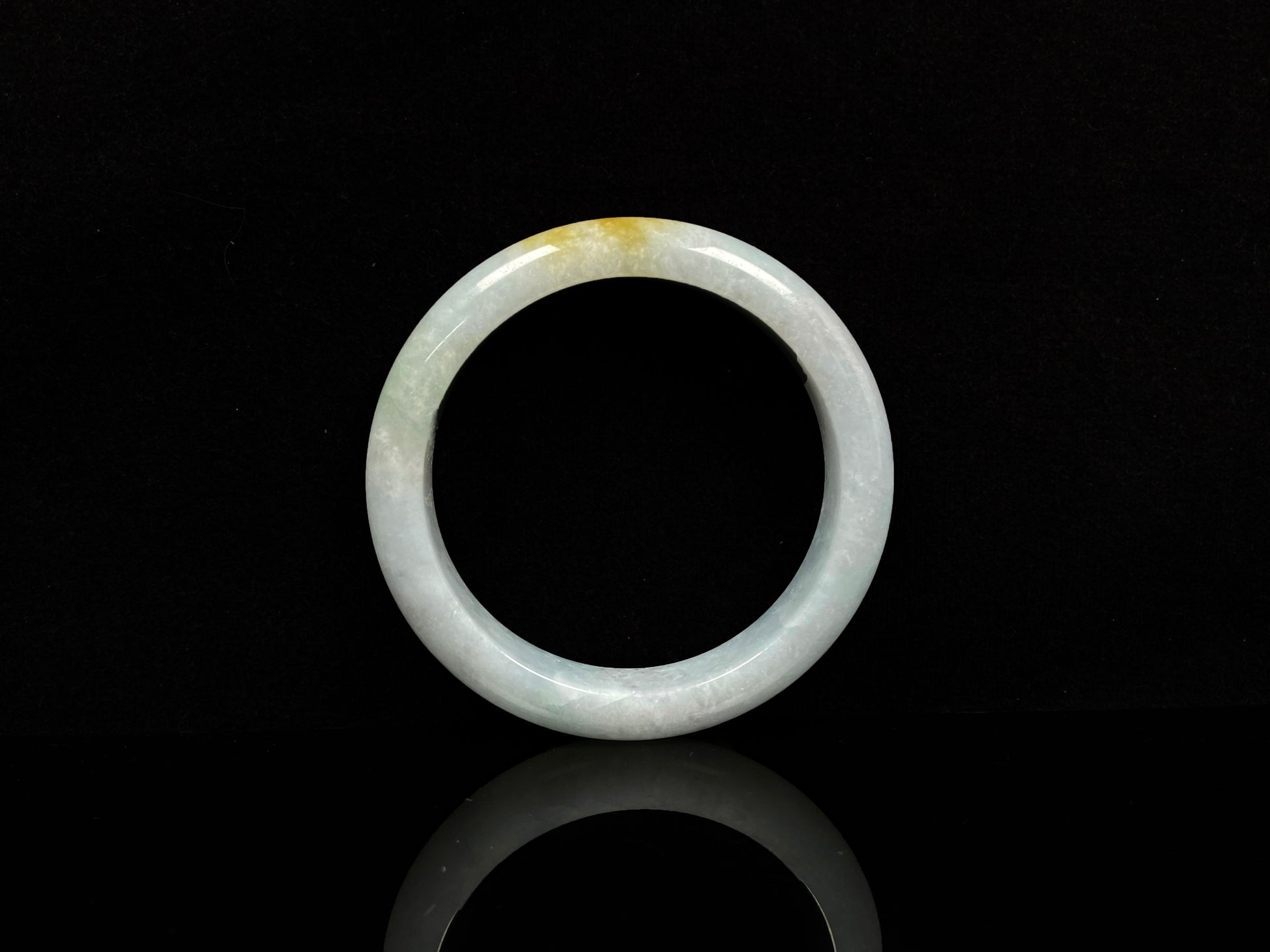 A white and gold jadeite bangle.