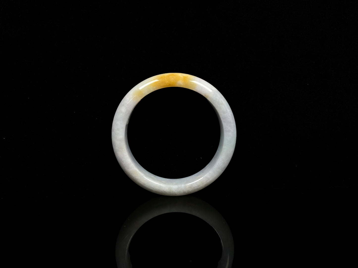 A white and gold jadeite bangle.