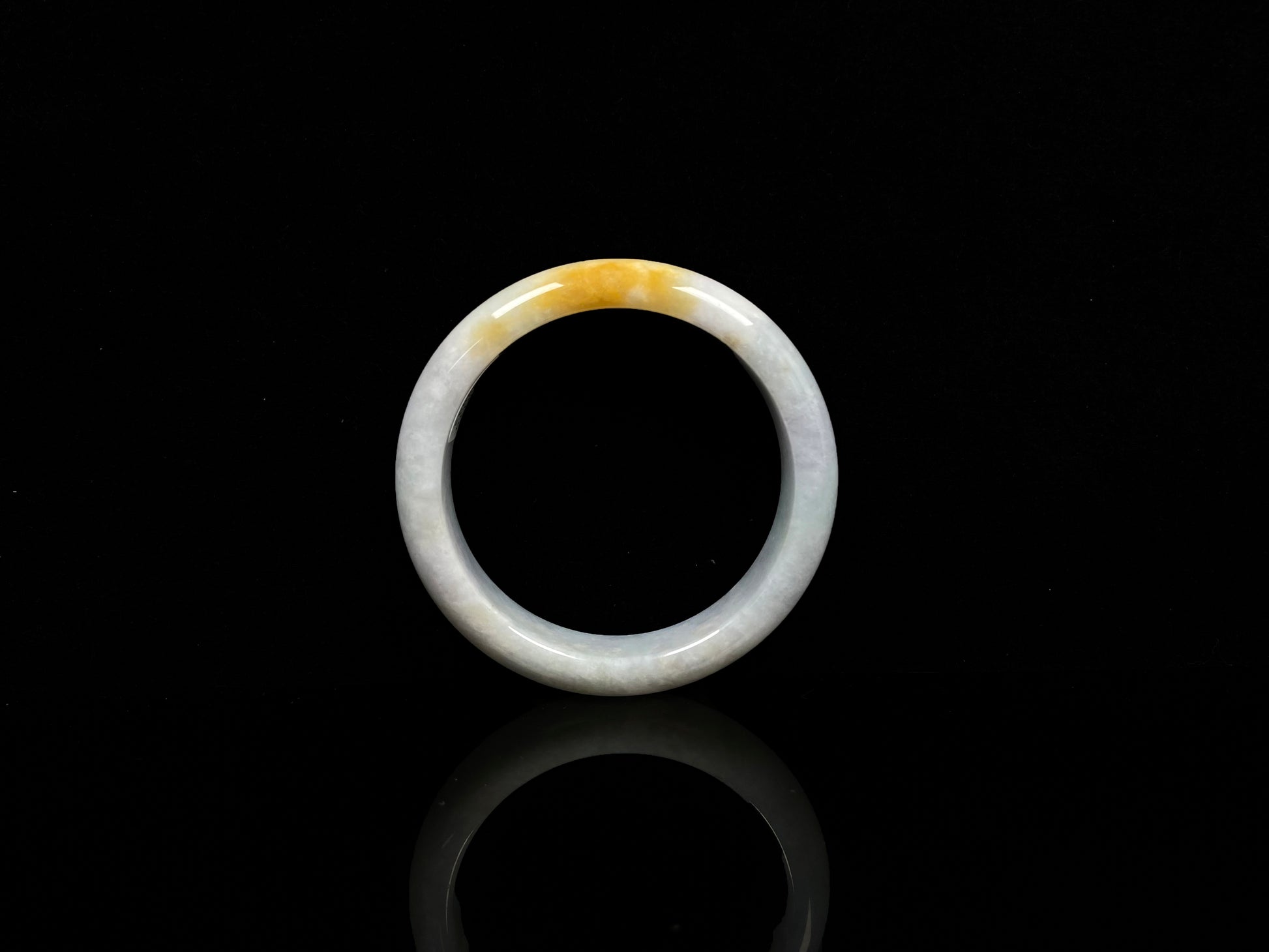 A white and gold jadeite bangle.