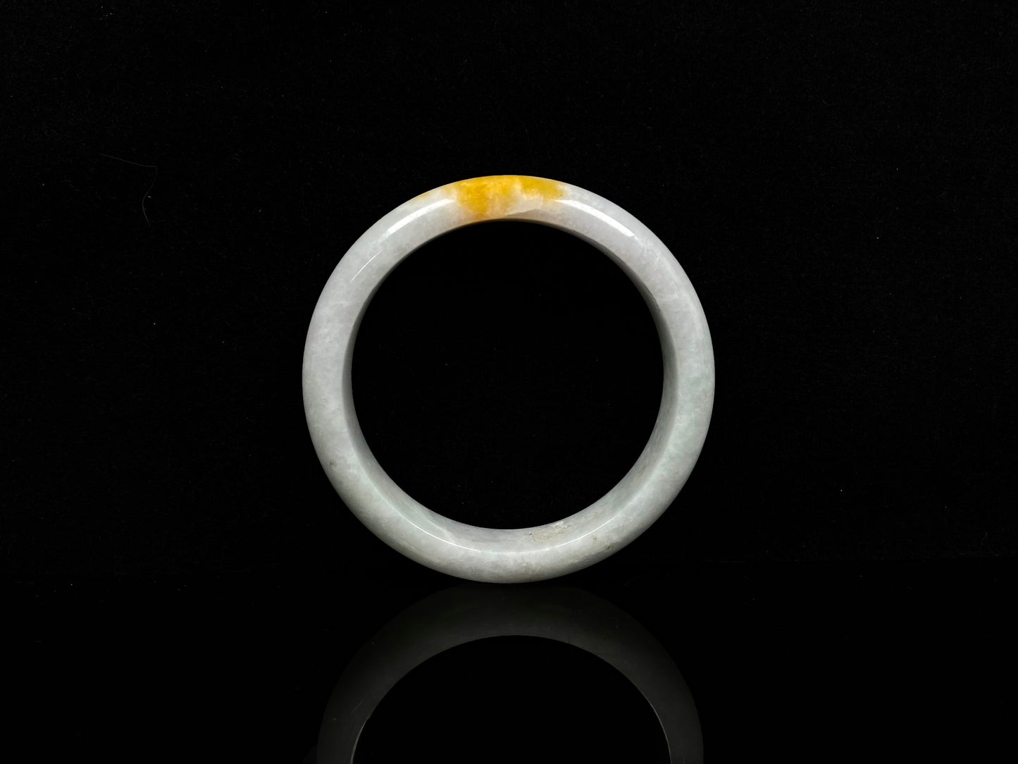 A white and gold jadeite bangle.