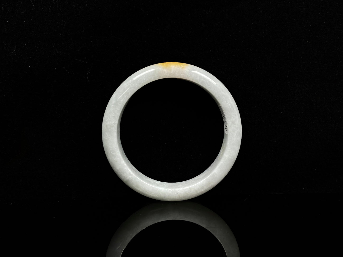 A white and gold jadeite bangle.