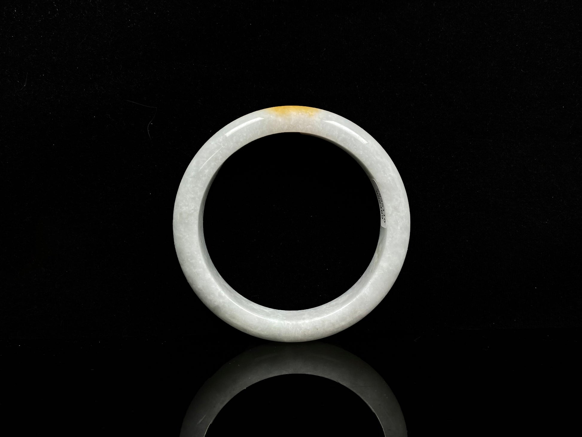A white and gold jadeite bangle.