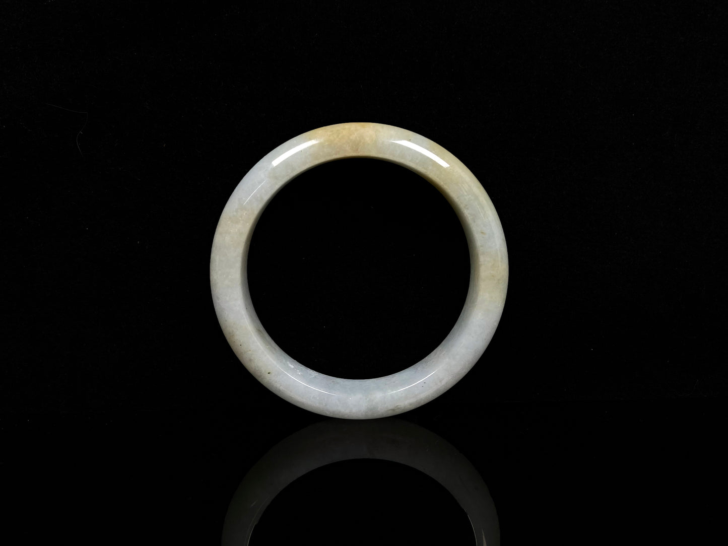 A white and gold jadeite bangle.