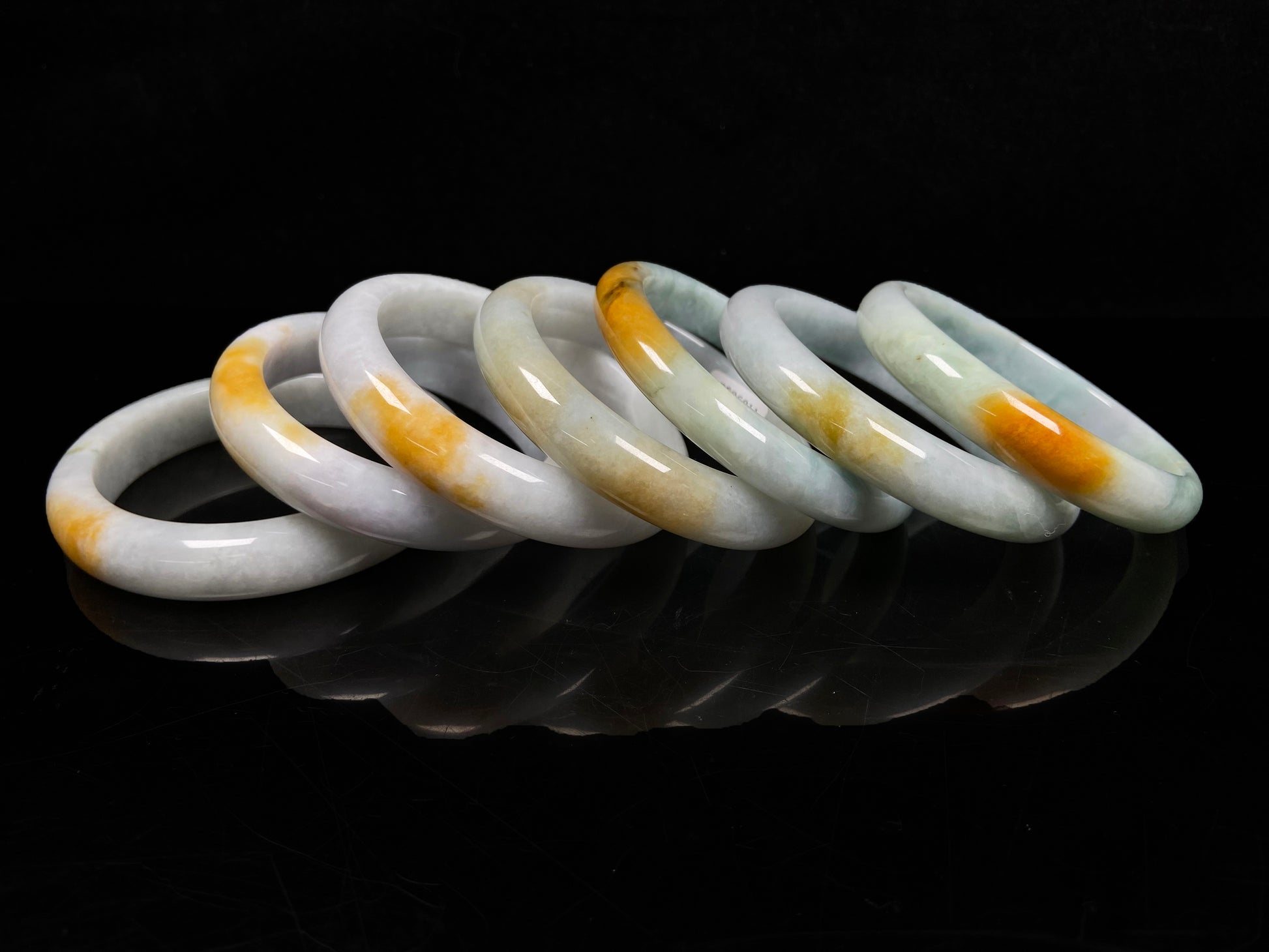 A white and gold jadeite bangle group.