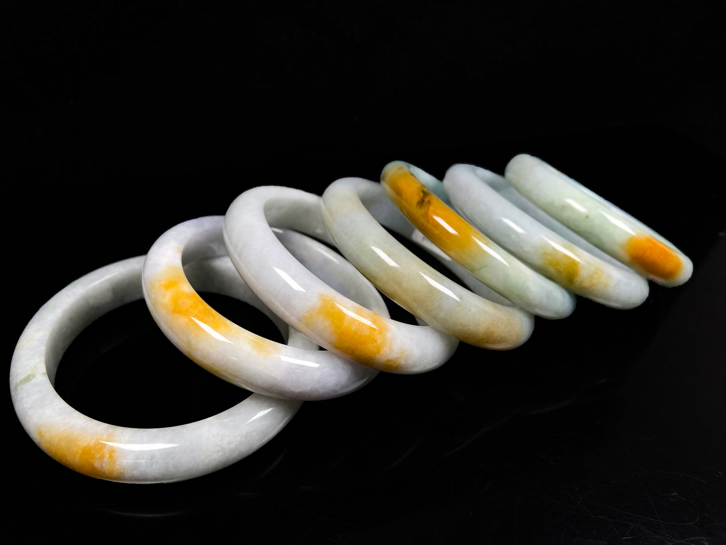 A white and gold jadeite bangle group.