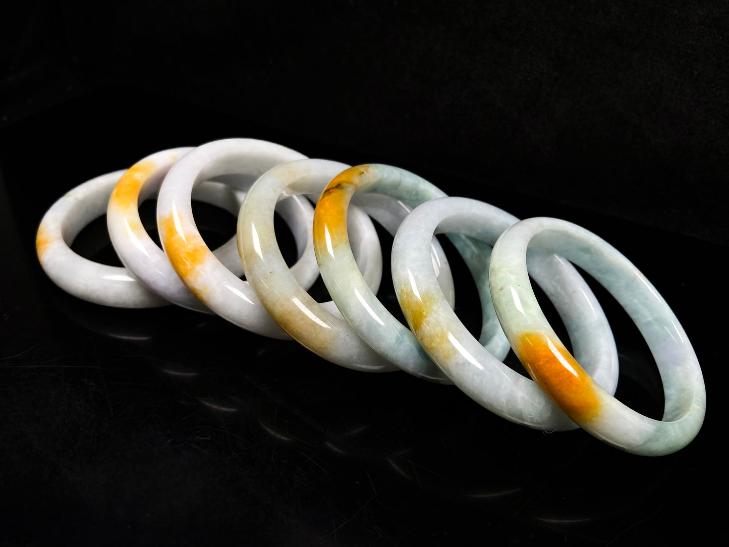 A white and gold jadeite bangle group.