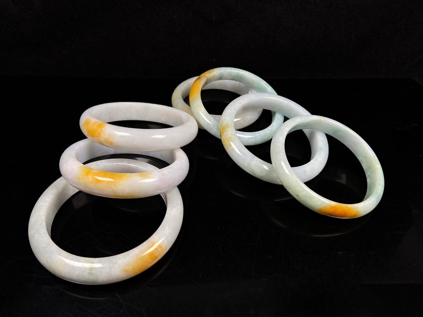 A white and gold jadeite bangle group.