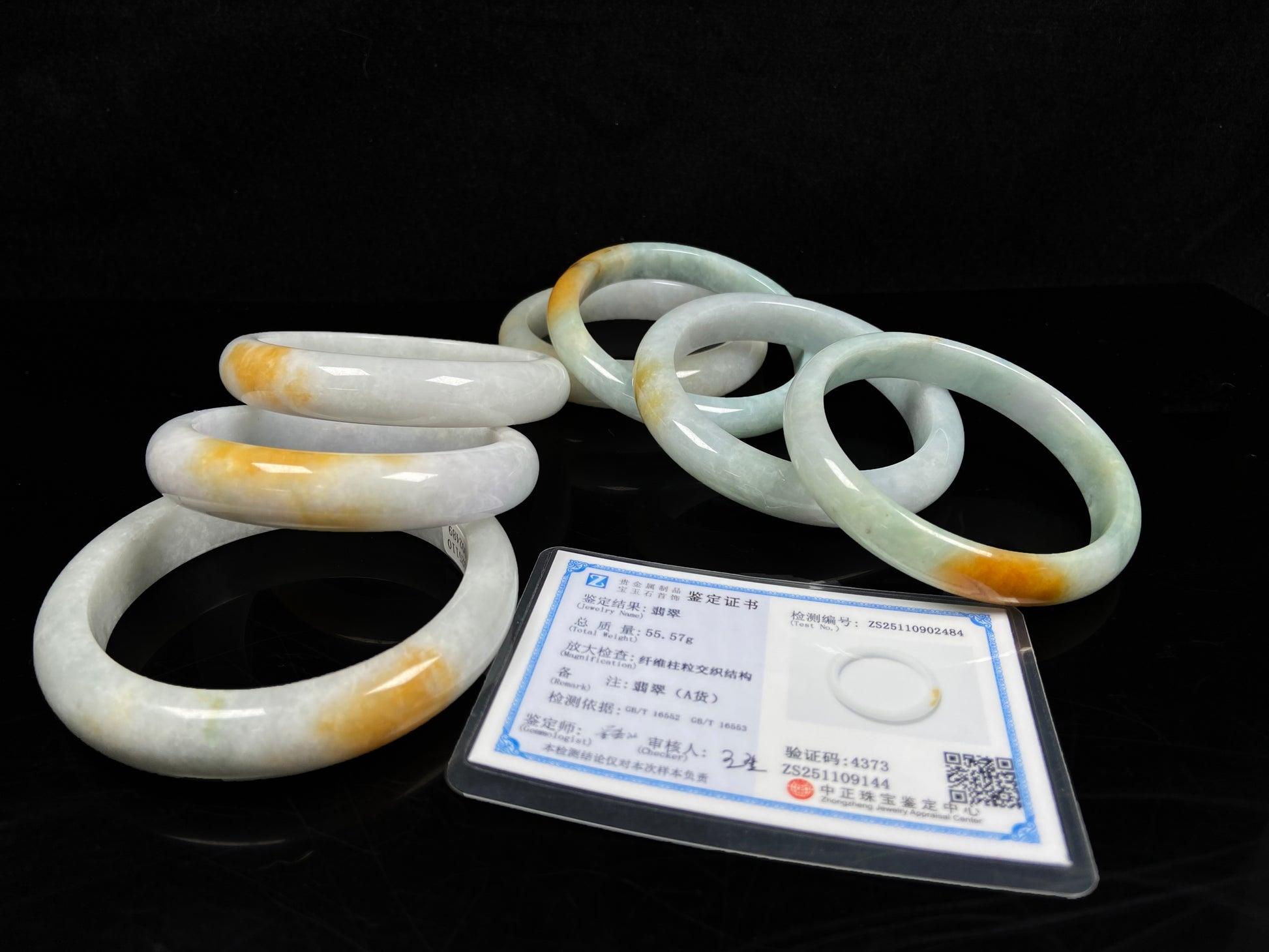 A white and gold jadeite bangle group.