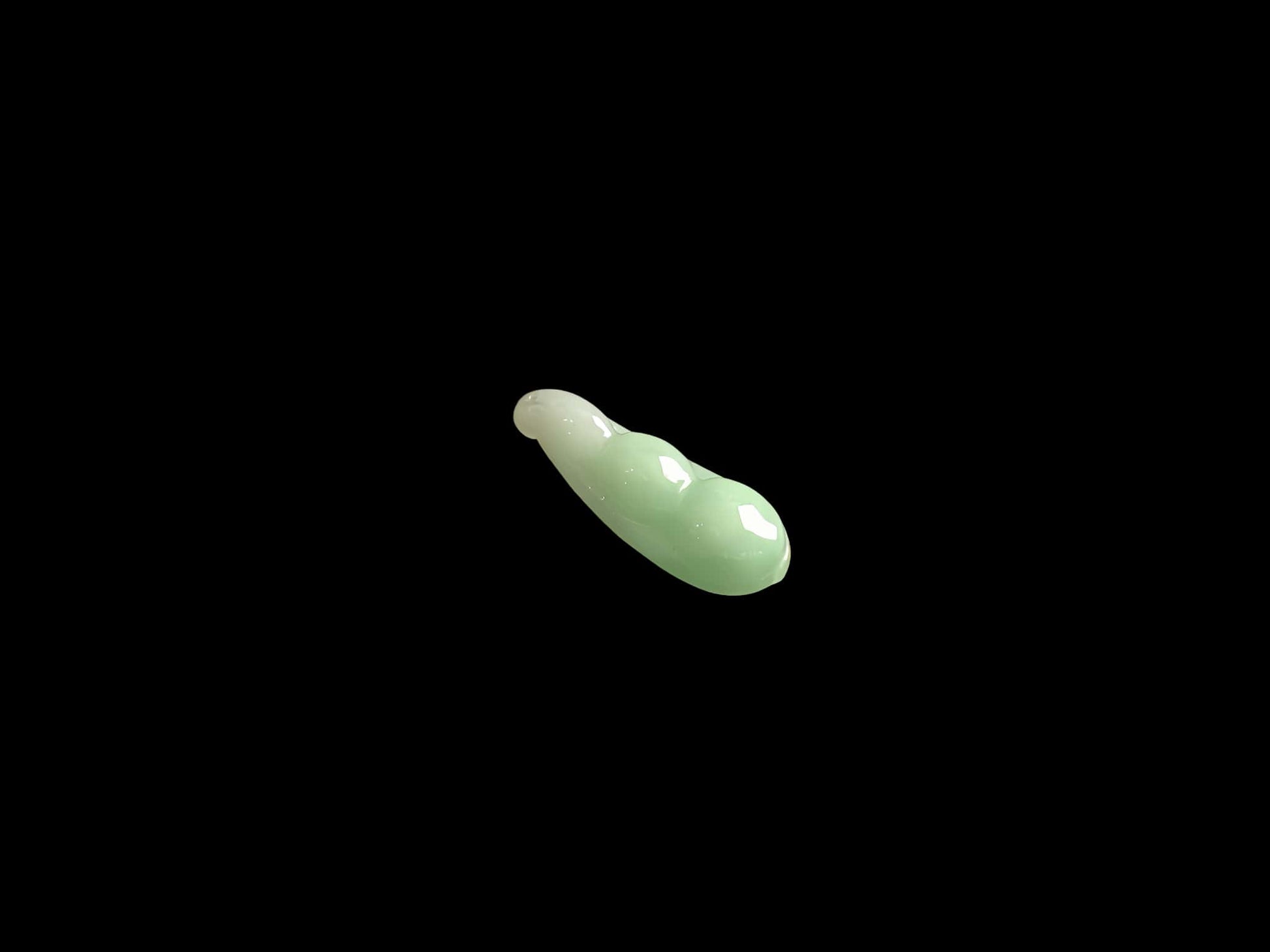 A pale green fortune pod loose jadeite.