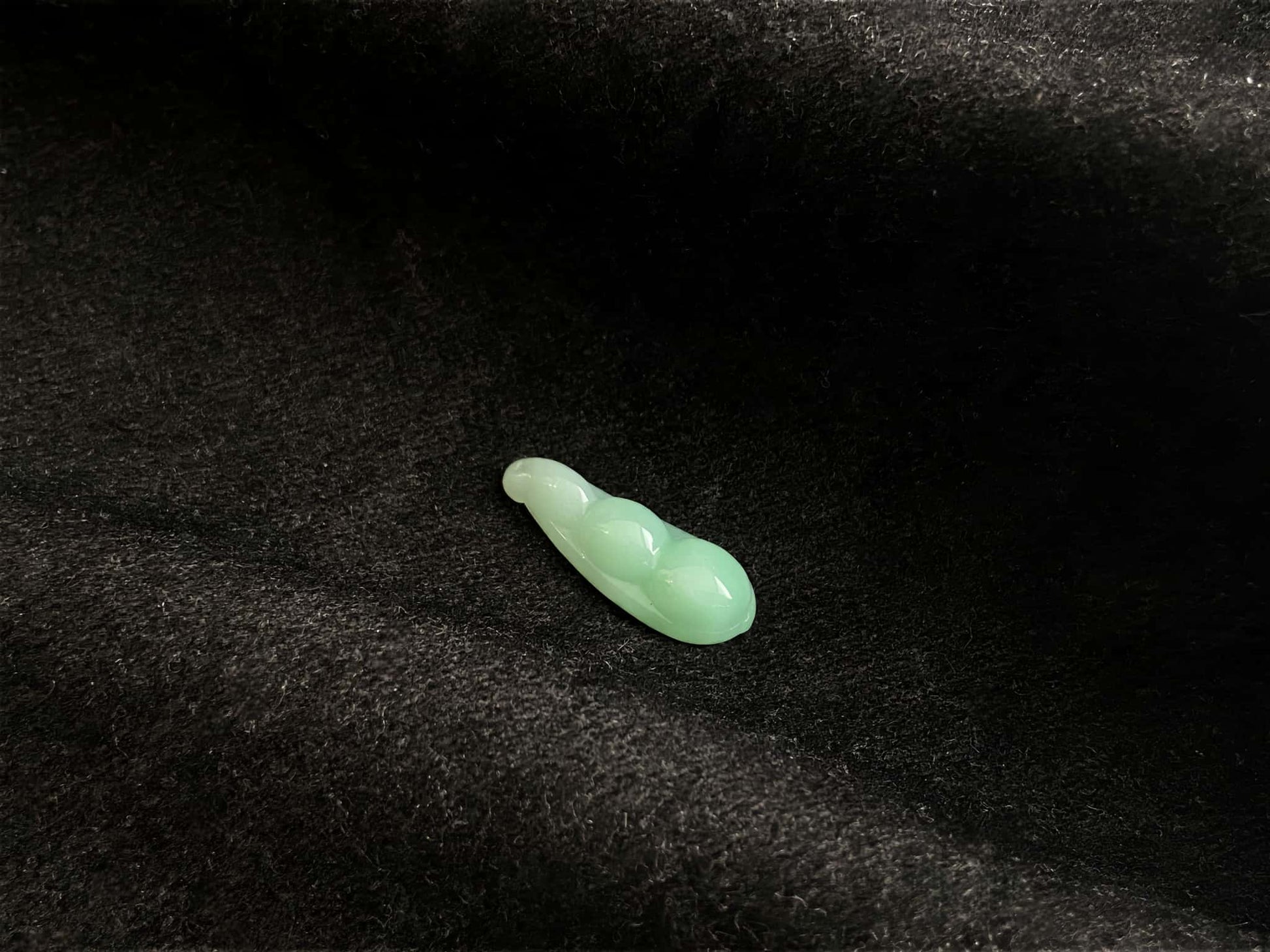 A pale green fortune pod loose jadeite.
