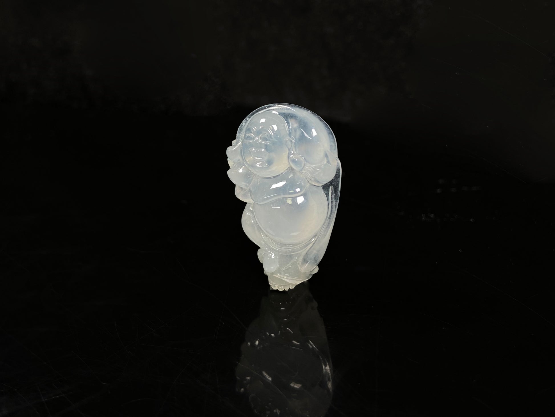 A translucent milky white maitreya buddha loose jadeite.