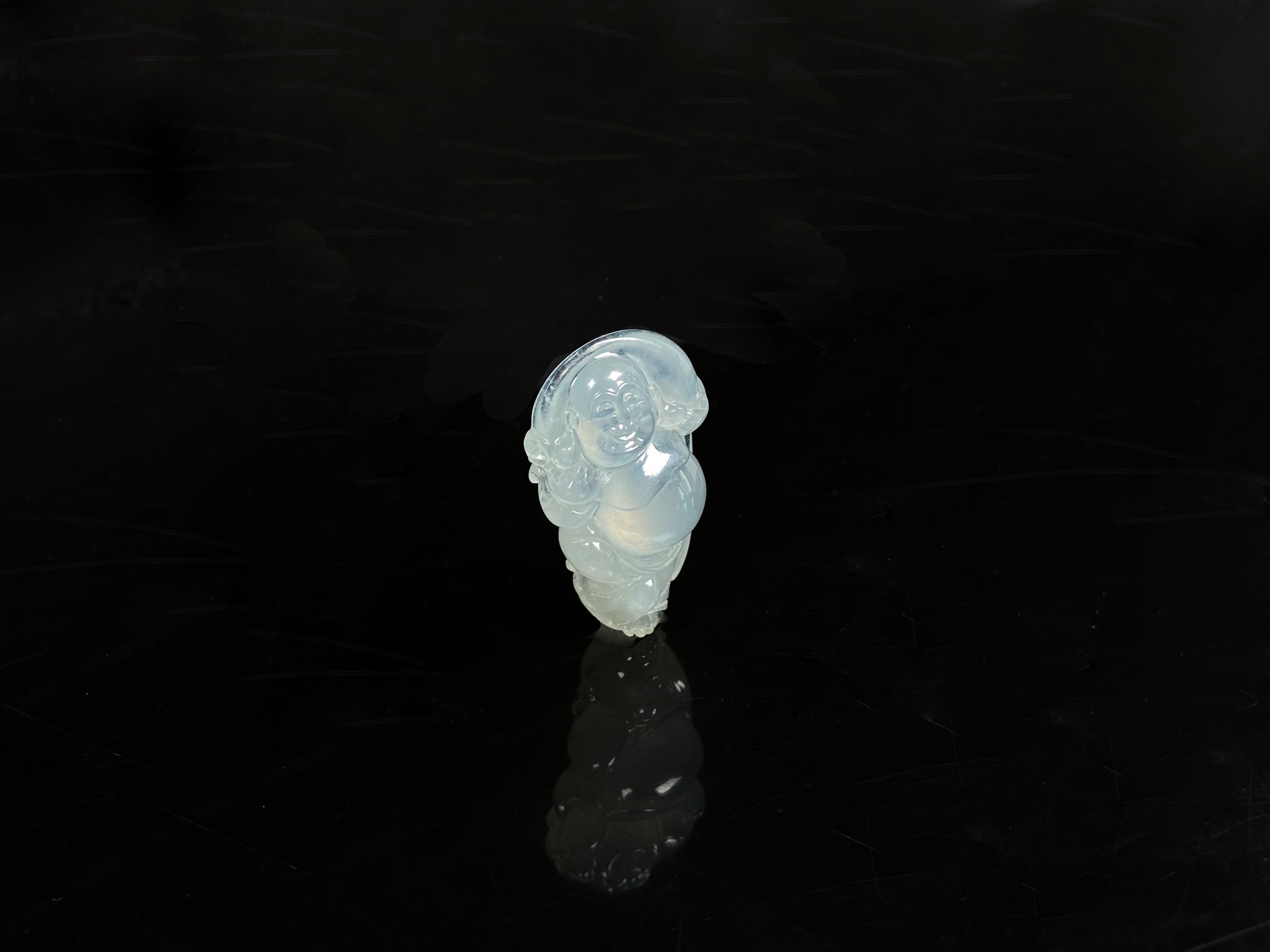 A translucent milky white maitreya buddha loose jadeite.