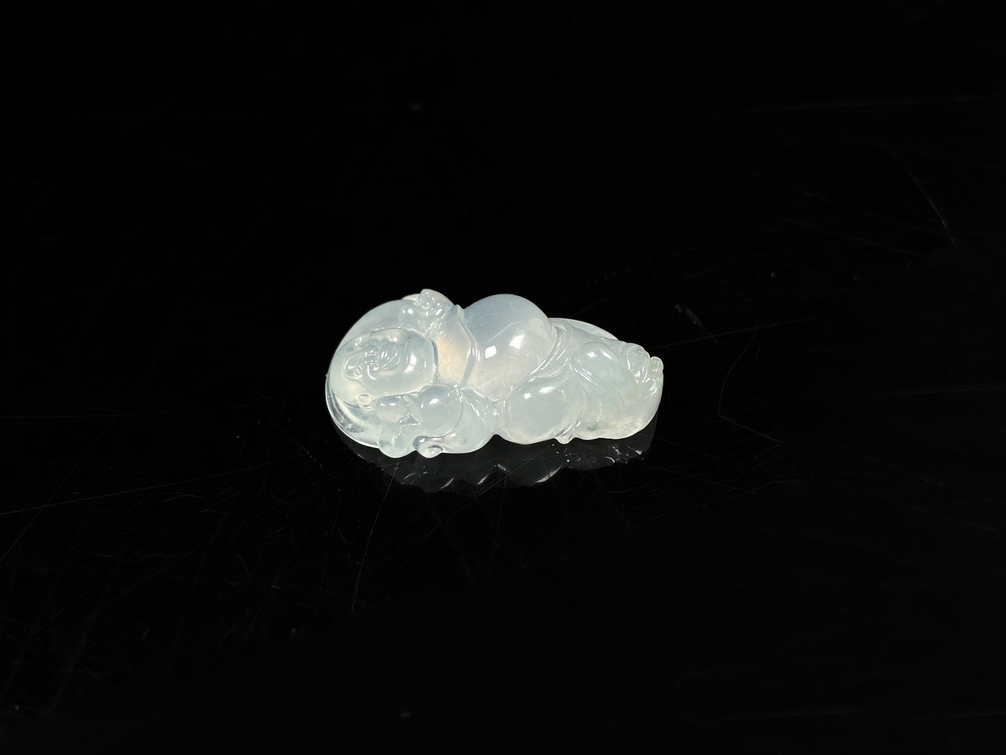 A translucent milky white maitreya buddha loose jadeite.