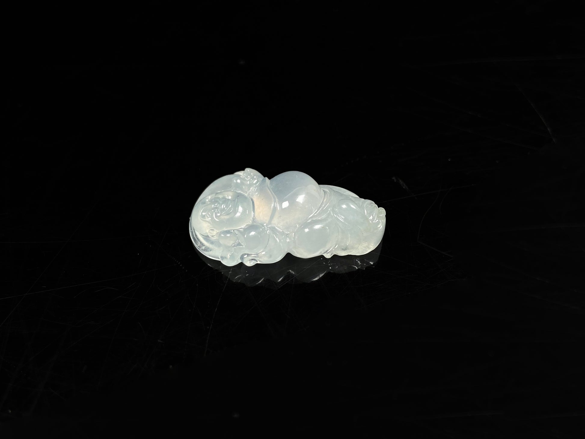 A translucent milky white maitreya buddha loose jadeite.