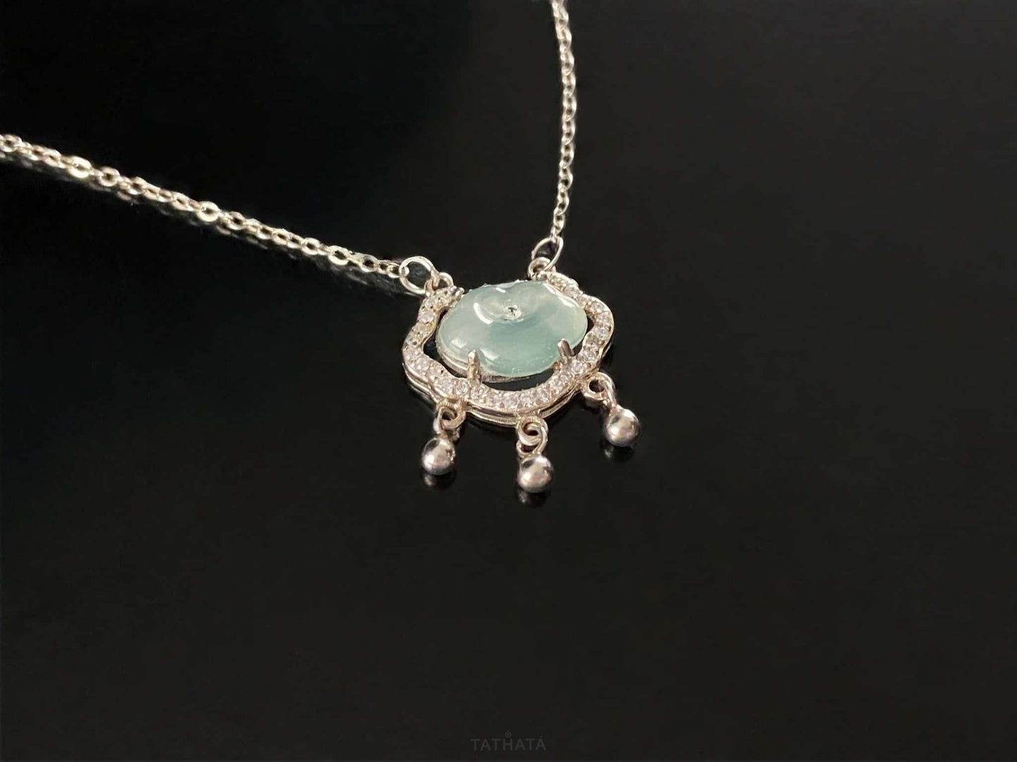 A ice green Ruyi chime jadeite pendant.