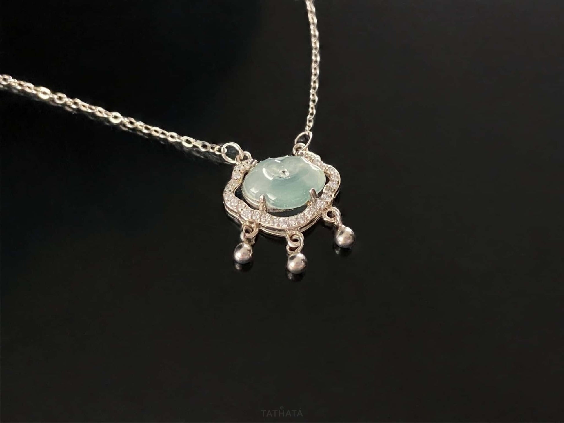 A ice green Ruyi chime jadeite pendant.