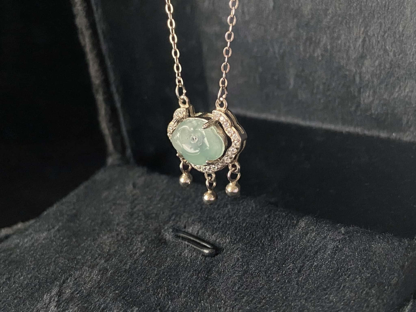 A ice green Ruyi chime jadeite pendant.