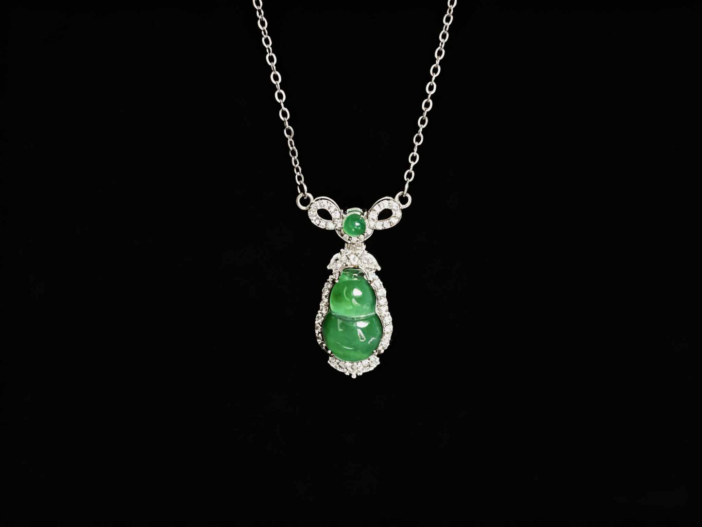 A glossy green lucky gourd jadeite pendant.