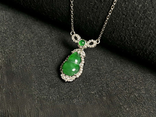 A glossy green lucky gourd jadeite pendant.